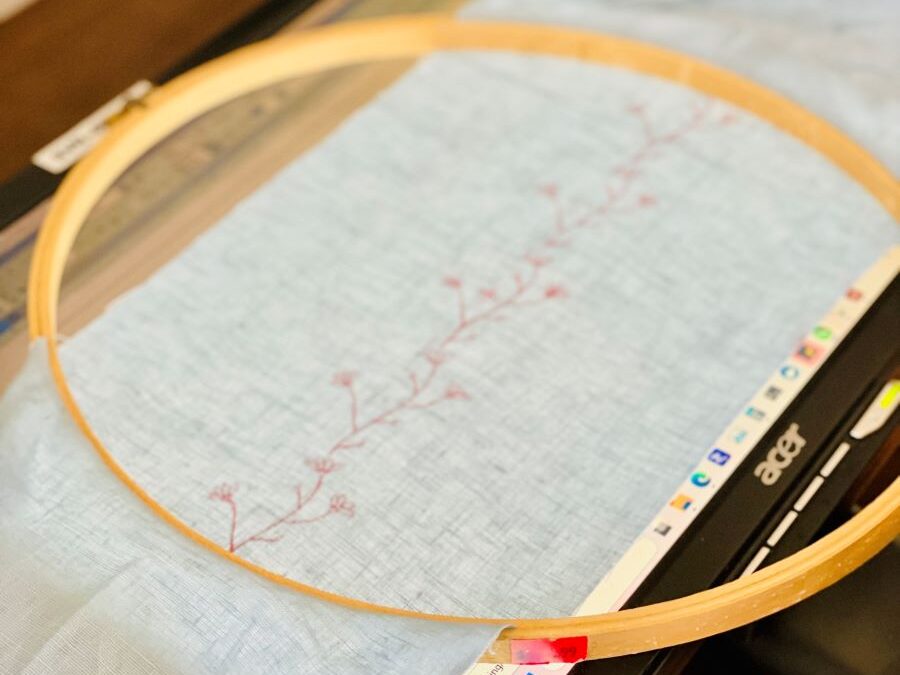 How to make a simple embroidered headband - headband pattern inside a large hoop on top of a computer moniter