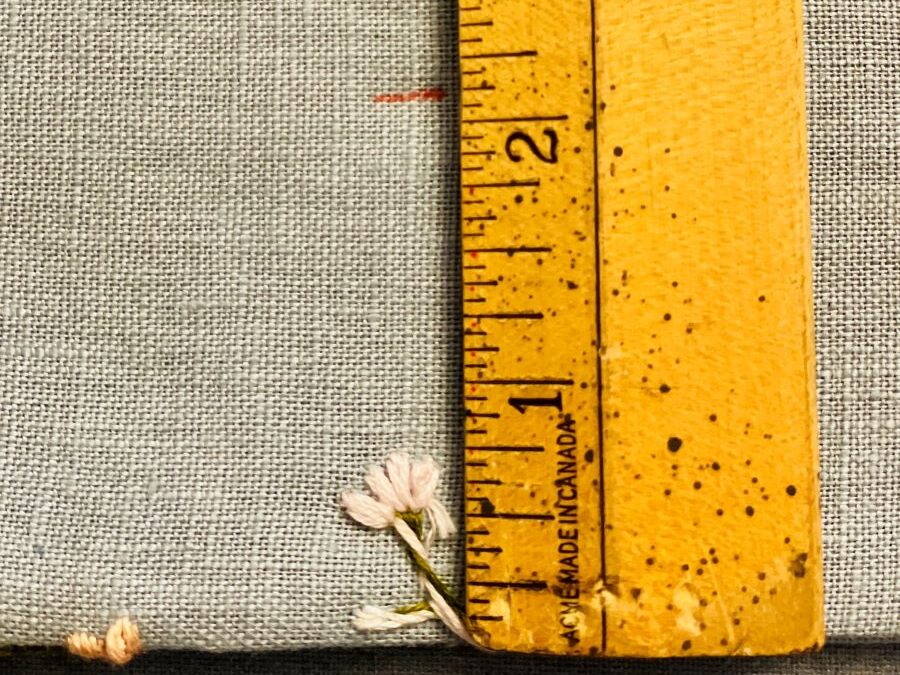 How to make a simple embroidered headband - measuring stick next to embroidered artwork